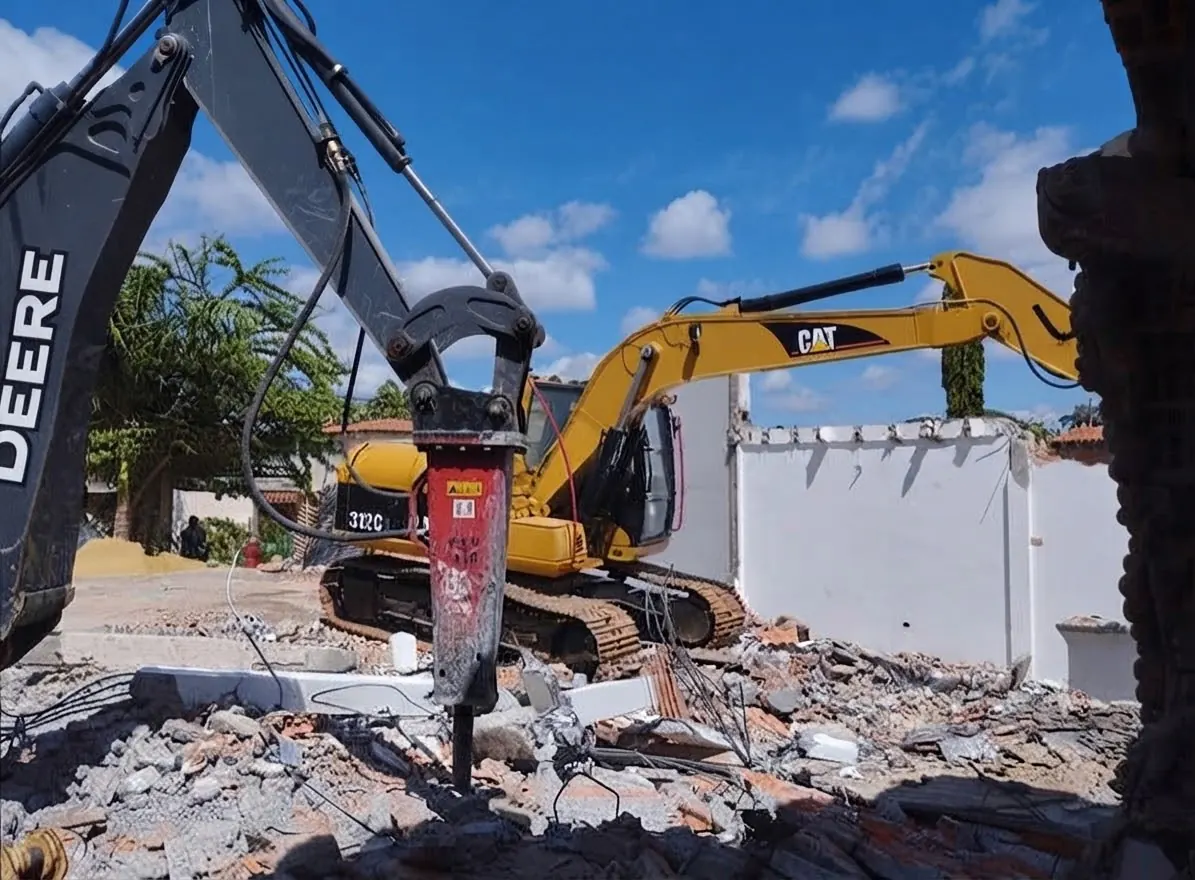 Excavator with a hydraulic breaker on demolition work