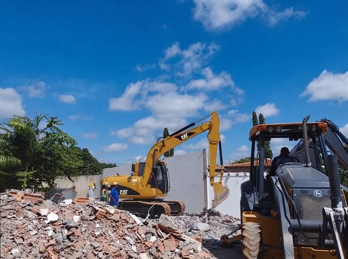 Excavator and backhoe loader working on a demolition