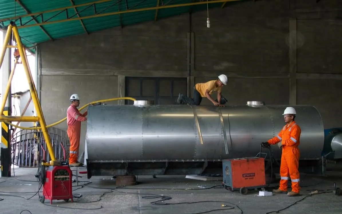 Welders working on a steel tank