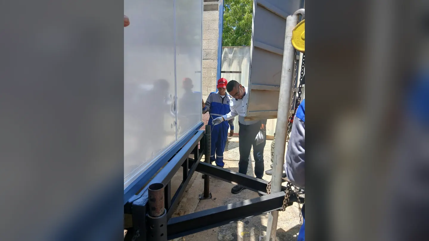 Staff adjusting the frame of a service unit